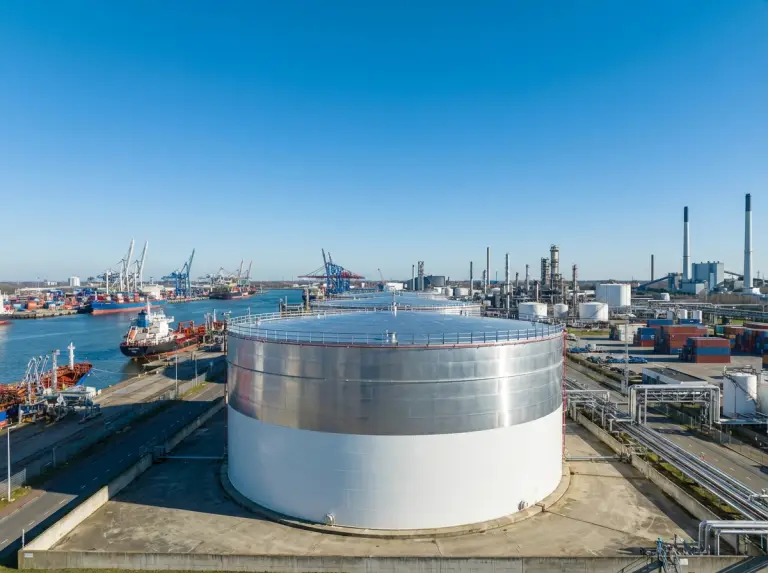 Coastal tank farm complex with rows of crude and product storage tanks